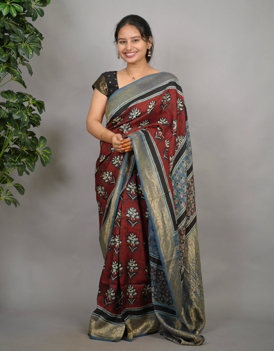 Brick red Ajrakh print Dola silk saree with traditional border from Looms & Tassels